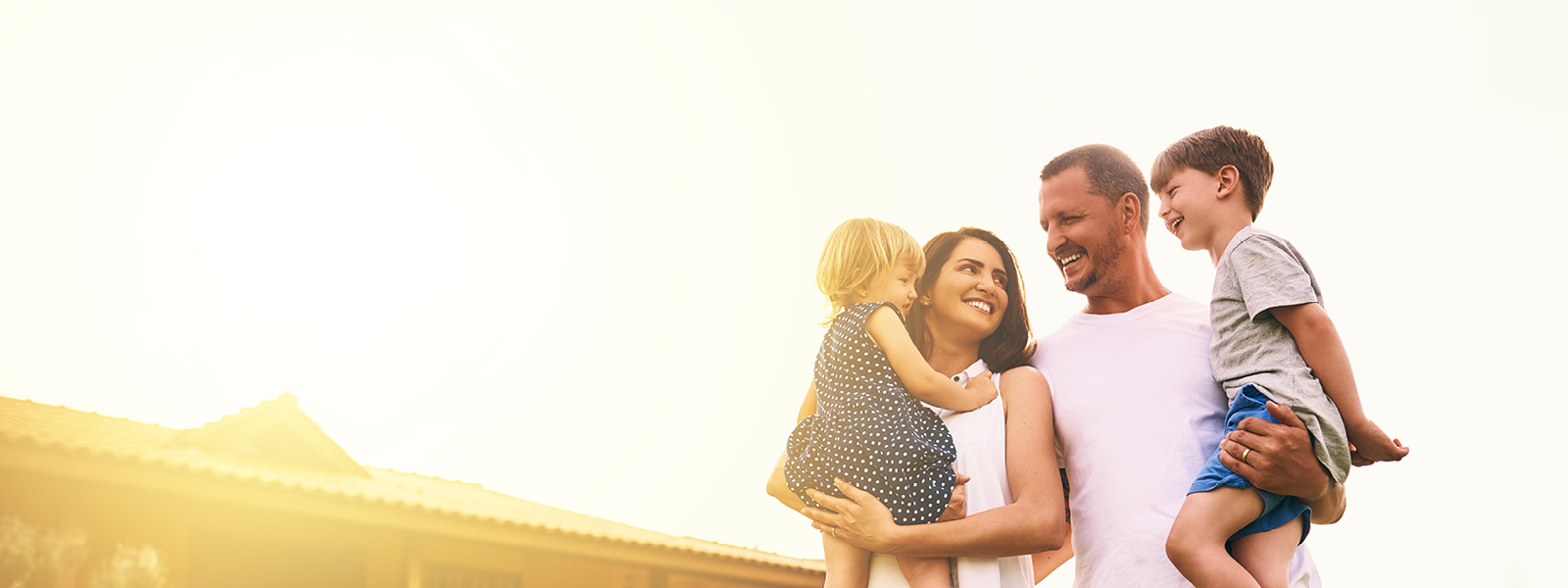 Happy family in front of house