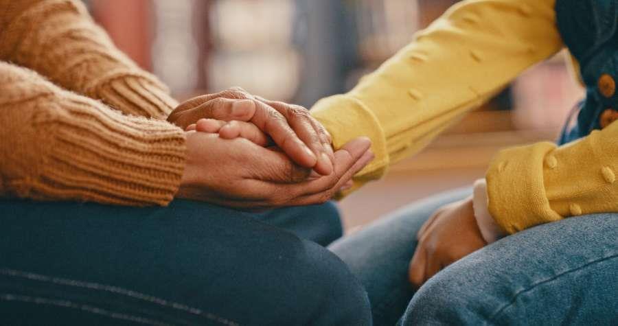 Close up of two people holding hands