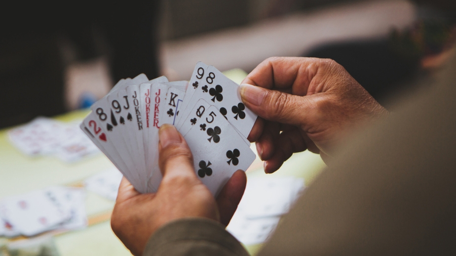 Close up of people playing a card game